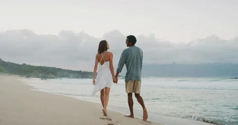 Happy couple stroll down the beach Stock Footage 101350242