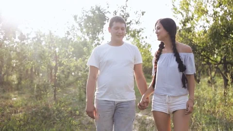 Happy couple strolling through the garden Stock Footage 80299792