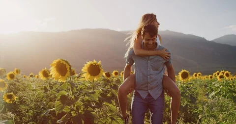 Happy couple in sunflower fields Stock Footage 106512809