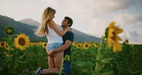 Happy couple in sunflower fields Stock Footage 106517463