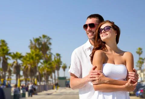 Happy couple in sunglasses over venice beach Stock Photos