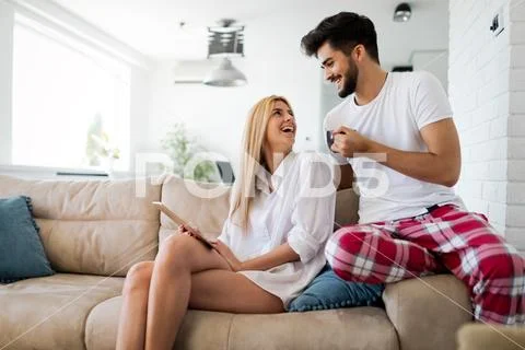 Happy couple surfing on tablet at home Stock Photos