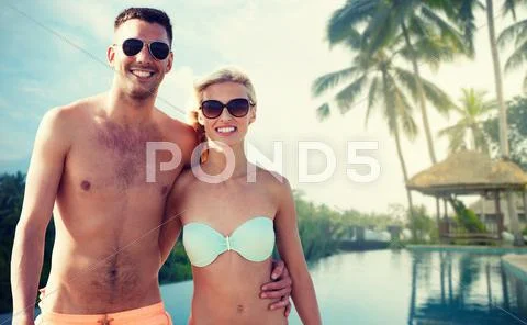 Happy couple in swimwear hugging over hotel resort Stock Photos