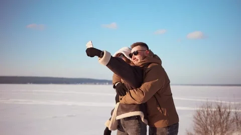 Happy couple takes a selfie while walking in winter Video stock 150330996