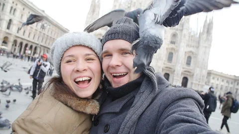 Happy Couple taking self portrait with pigeon. Traveling and relationship Stock Footage 101015490