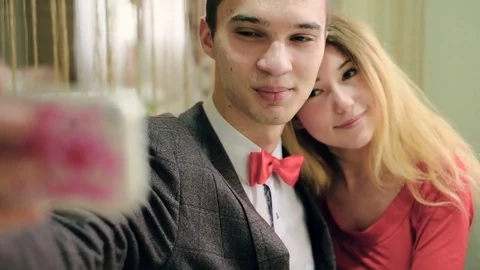 Happy couple taking selfie photo with cellphone sitting in cafe like Video stock 73834026
