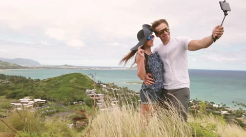Happy couple taking selfie self-portrait photo hiking, Oahu, Hawaii Stock Footage 58146105