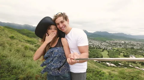 Happy couple taking selfie self-portrait photo hiking, Oahu, Hawaii Stock Footage 58146418