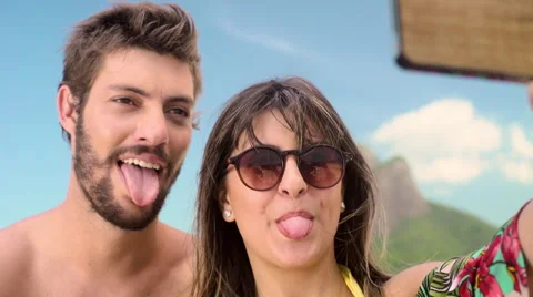 Happy couple taking a selfie on smartphone at Ipanema beach Stock Footage 59441440