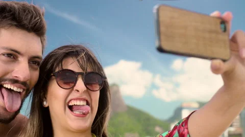 Happy couple taking a selfie on smartphone at Ipanema beach Stock Footage 59441518