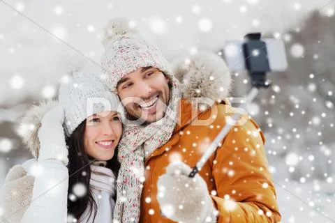 Happy couple taking selfie by smartphone in winter Stock Photos