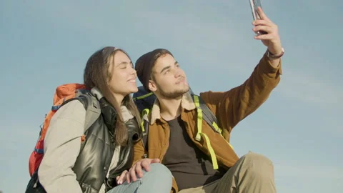 Happy couple taking selfie while hiking together 動画素材 172478398
