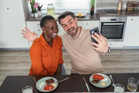 Happy Couple Taking Selfie While Having Breakfast in the Kitchen Stock Photos