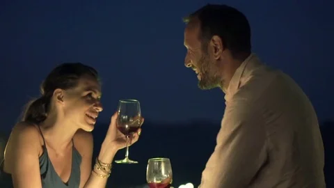 Happy couple talking and drinking wine in the bar in the evening Stock Footage 75888115