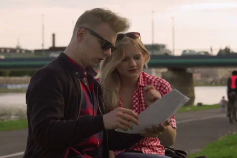 Happy couple talking and reading important papers Stock Footage 50573372