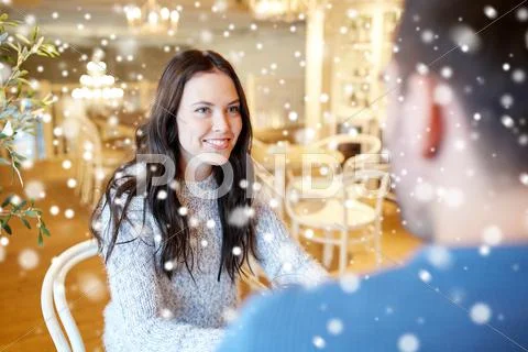 Happy couple talking at cafe or restaurant Stock Photos