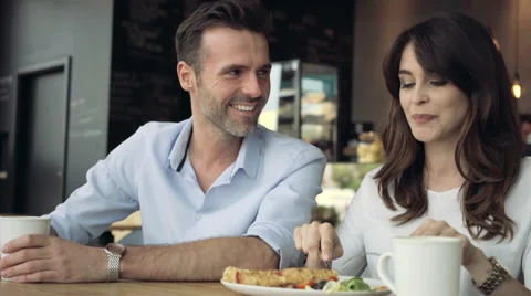 Happy couple talking during lunch at cafe Stock Footage 64653578