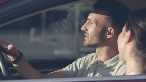 The happy couple talking inside a car. slow motion Stock Footage 137473206