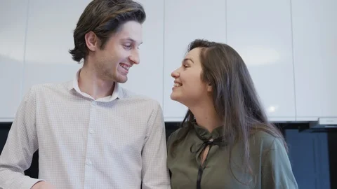 Happy couple talking in the kitchen Stock Footage 99941722