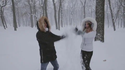 Happy couple throwing snow up Stock Footage 73405627