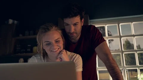 Happy couple using laptop Stock Footage 74423954