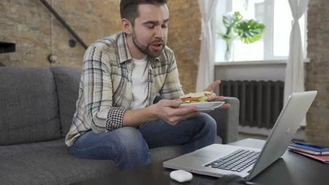 Happy couple using laptop for video call in the living room Video stock 233430679