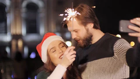 Happy couple using smart phone talking to friends congratulates Merry Christmas Video stock 142234190