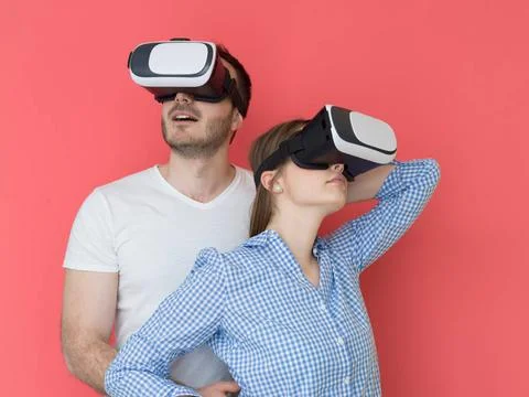 Happy couple using VR-headset glasses of virtual reality happy young coupl... Stock Photos