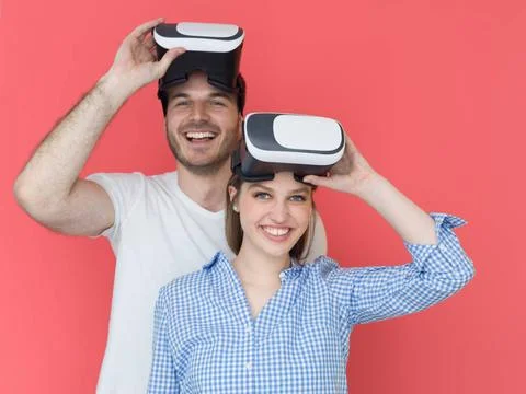 Happy couple using VR-headset glasses of virtual reality happy young coupl... Stock Photos