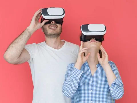 Happy couple using VR-headset glasses of virtual reality happy young coupl... Stock Photos