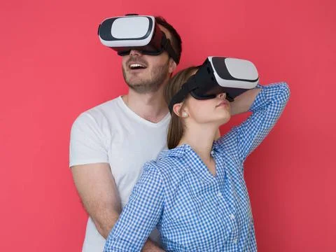 Happy couple using VR-headset glasses of virtual reality happy young coupl... Stock Photos