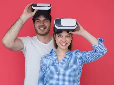 Happy couple using VR-headset glasses of virtual reality happy young coupl... Stock Photos