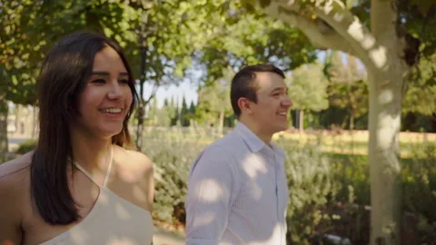 Happy couple walking and talking in a park Stock Footage 303854573