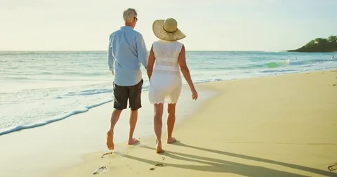 Happy Couple Walking on the Beach at Sunset Stock Footage 74284446