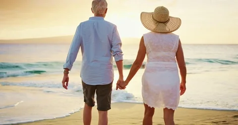 Happy Couple Walking on the Beach at Sunset Stock Footage