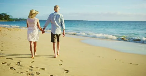 Happy Couple Walking on the Beach at Sunset Stock Footage 74284643