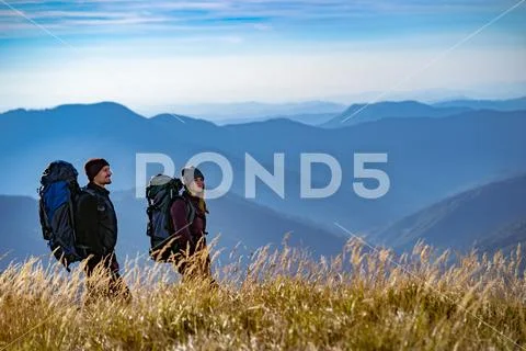 The happy couple walking on the mountain Stock Photos