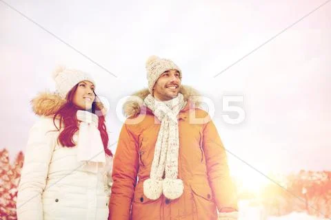 Happy couple walking over winter background Stock Photos