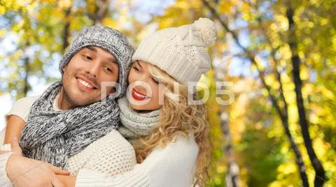 Happy couple in warm clothes over autumn Stock Photos