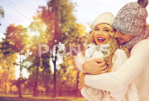 Happy couple in warm clothes over autumn Stock Photos
