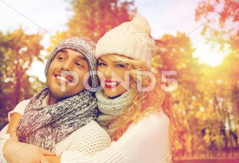 Happy couple in warm clothes over autumn Stock Photos