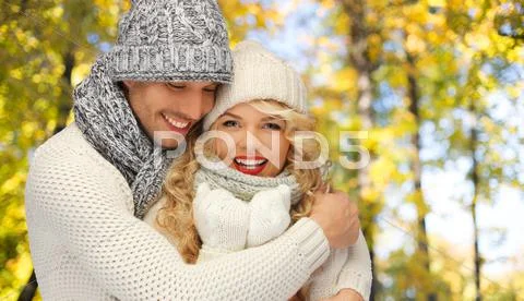 Happy couple in warm clothes over autumn Stock Photos