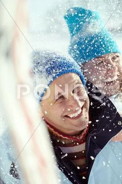 Happy couple on winter vacations smiling in snow Stock Photos