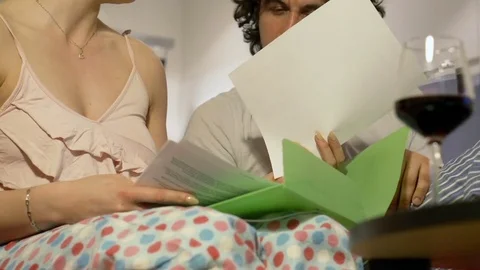 Happy couple working together on papers at night, steadycam shot Stock-Footage 72018421