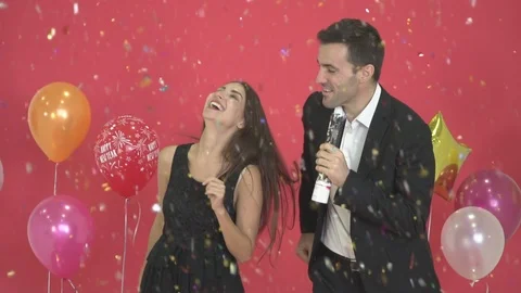 Happy couples dancing with New Year's decorations and red backgrounds. Video stock 121131961