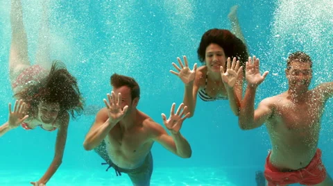 Happy couples swimming underwater | Stock Video | Pond5