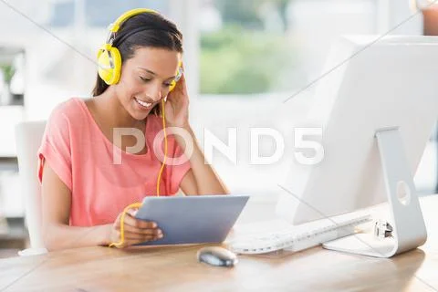 Happy Creative Businesswoman Listening Music With Her Tablet