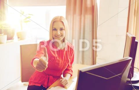 Happy creative female office worker with computers Stock Photos
