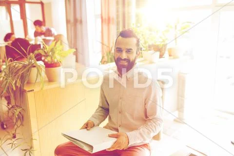 Happy creative male office worker with folfer Stock Photos