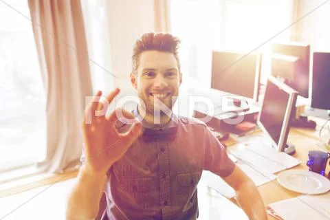 Happy creative male office worker showing ok sign Stock Photos